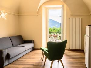 een woonkamer met een bank en een raam bij Apartment Atmosfere sul lago by Interhome in Porto Valtravaglia