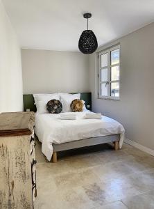 a bedroom with a bed with two pillows on it at Les Estrelles in Saint-Rémy-de-Provence