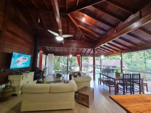 a living room with a couch and a dining room at Recanto R-12 in Rodeio Doze