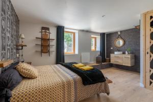 a bedroom with a large bed and a bathroom at Maison Melanie - Superbe Chalet proche des pistes in Les Angles