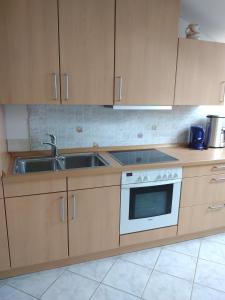 a kitchen with a sink and a stove at Bernie Apartments in Poreč