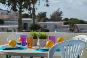 a table with a plate of oranges on it at Vitamin Sea Protaras in Protaras