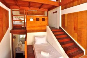 
a room with a bunk bed and a ladder at Boracay Coco Huts in Boracay
