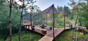 a wooden deck with a tent on top of it at Agroturystyka na Słonecznej Orawie u Dzikich in Jabłonka