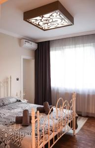 a bedroom with a bed with a chandelier at Tsarevets Apartament-Veliko Tarnovo in Veliko Tŭrnovo