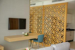 a room with a wooden partition with a table and a tv at Zephyr Agadir in Agadir