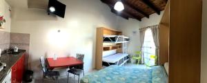 a small room with a bed and a table and a desk at departamento acosta 2 in Paraná