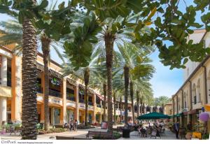 a street with palm trees in a shopping center at Casa del Sol 2bd 1ba Cottage Private Pool in West Palm Beach