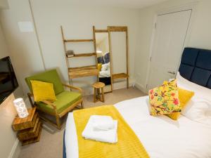 劍橋的住宿－麗晶公寓酒店，配有床、椅子和电视的房间