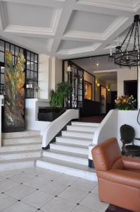 a lobby with stairs and a couch in a building at Hotel Bellevue in Amboise