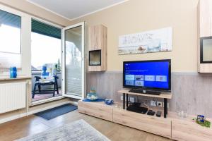 TV a/nebo společenská místnost v ubytování Ferienwohnung Haus Heimathafen