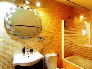 a bathroom with a sink and a mirror and a toilet at Casa Siesta in Granada +21 photos