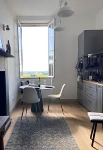 uma cozinha com mesa e cadeiras e uma janela em Romantic Gite nr St Emilion with Private Pool and Views to Die For em Pujols-sur-Ciron
