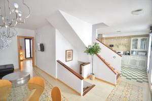 a living room with a staircase and a dining room at Casa Siesta in Granada
