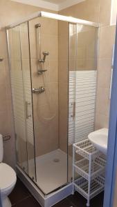 a bathroom with a shower with a toilet and a sink at RIVA Ośrodek Wypoczynkowy in Więcbork +57 photos