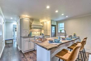 a large kitchen with a large island with chairs at Modern Winter Garden Cottage 16 Mi to Disney in Orlando