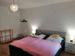 a bedroom with a bed with two pillows on it at Slávik Apartment in Dunajská Streda