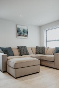 a living room with a couch and a window at 2 The Mews, Upper Bath Street in Cheltenham