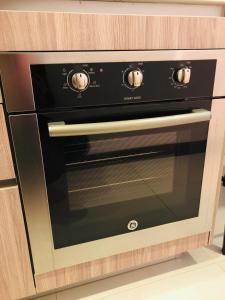 a black oven sitting inside of a kitchen at APARTAESTUDIO AMOBLADO,FURNISHED STUDIO APARTMENT WIFI gratuito in Bogotá