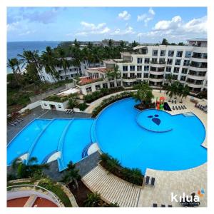 an overhead view of a large swimming pool at a resort at Kilua Beach Resort in Mombasa