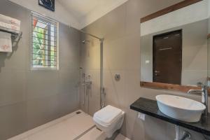 a white bathroom with a sink and a toilet at SaffronStays Casa Manga, Karjat - pet-friendly pool villa near ND's Film World and Saltt in Karjat +40 photos