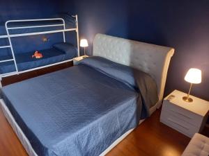 a bedroom with two bunk beds with blue walls at CASETTA delle ROSE in Assisi