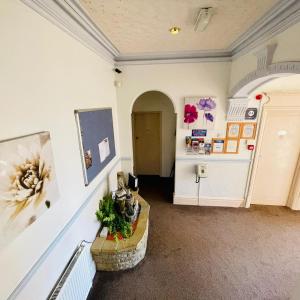 a hallway with a hallway leading to a room with a door at Lyndene Holiday Apartments in Skegness