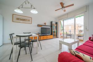ein Wohnzimmer mit einer Couch und einem Tisch in der Unterkunft HomeHolidaysRentals Margot - Costa Barcelona in Pineda de Mar