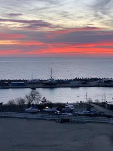 a marina with boats in the water at sunset at PASHA HOTEL in Eforie Nord