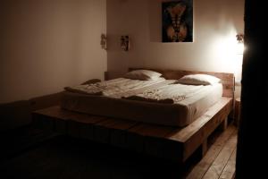 a bedroom with a bed on a wooden platform at Intense Room in Remeţi +17 photos