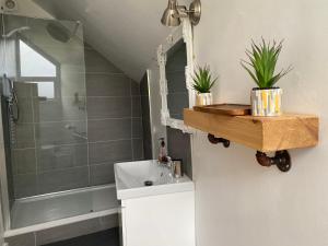 a bathroom with a sink and a shower at Delightful One Bed Lake District Cottage in Penrith +17 photos