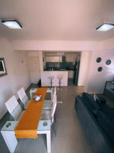 a living room with a table and a couch at Patio San Ignacio in San Juan +5 photos