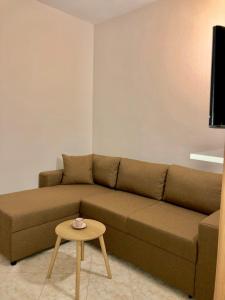a living room with a brown couch and a table at Apartments Ela in Ulcinj