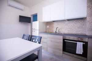 a kitchen with a sink and a stove top oven at Donnosanto Residence Pantanagianni in Torre Santa Sabina