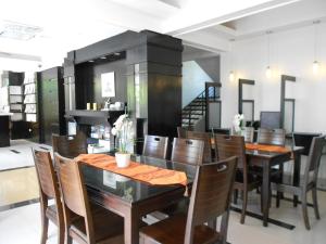 a dining room with wooden tables and chairs at One Crescent Place Hotel in Boracay