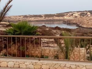 Blick auf einen Wasserkörper von einem Zaun in der Unterkunft Residence Punta Sottile A 2 passi dalla spiaggia di cala francese Lampedusa in Lampedusa