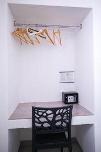 a room with a desk with a chair and shoes on a wall at Donnosanto Residence Pantanagianni in Torre Santa Sabina
