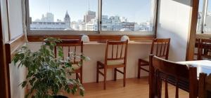 a dining room with a table and chairs and a window at Hotel Continental in Montevideo +32 photos
