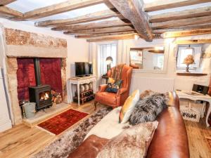 a living room with a couch and a fireplace at The Mouse House in Elton