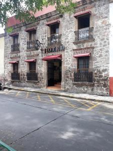 un edificio con un letrero de hotel al lado de una calle en Hotel el Carmen, en Morelia