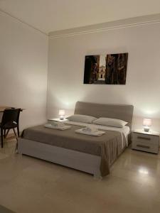 una camera con letto, 2 lampade e scrivania di Suite San Cataldo a Taranto