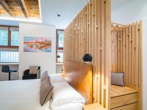 a bedroom with a bed and a wooden wall at Design Rooms Verona in Verona