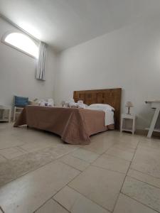 a room with a bed and a table in it at Sal.to nel blu in Leverano