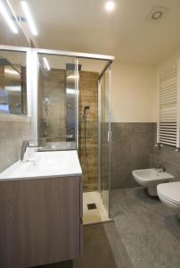 a bathroom with a sink and a shower and a toilet at Residence Ables in Valfurva
