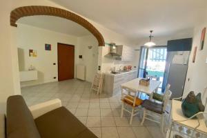 a kitchen and living room with a table and chairs at Langhe&Tartufi, a Ricca di Diano d'Alba in Diano dʼAlba