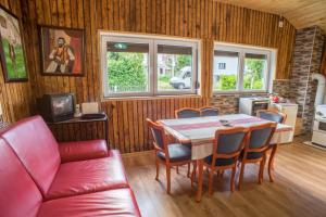 a living room with a table and chairs and a couch at Vila Tijana in Žabljak