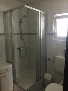 a shower with a glass door in a bathroom at Haus Serena oben in Sonnenalpe Nassfeld