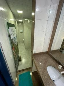 a bathroom with a toilet, sink, and mirror at Da Orla Pampulha Hostel in Belo Horizonte
