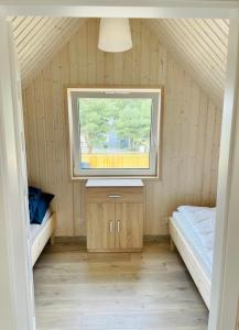 a small room with a window in a house at Czerwony Domek in Sasino