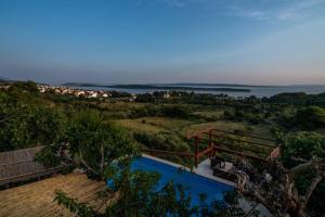 a view of the ocean from a house with a swimming pool at Etno Villa with a pool - Matušanovi Dvori Rab in Rab